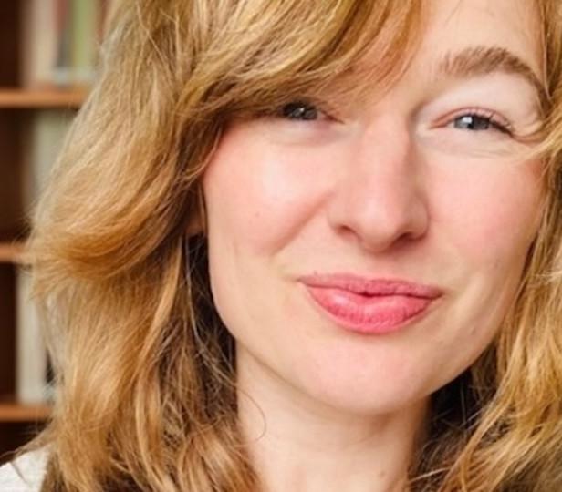 Headshot of Krista Williams in front of a bookshelf